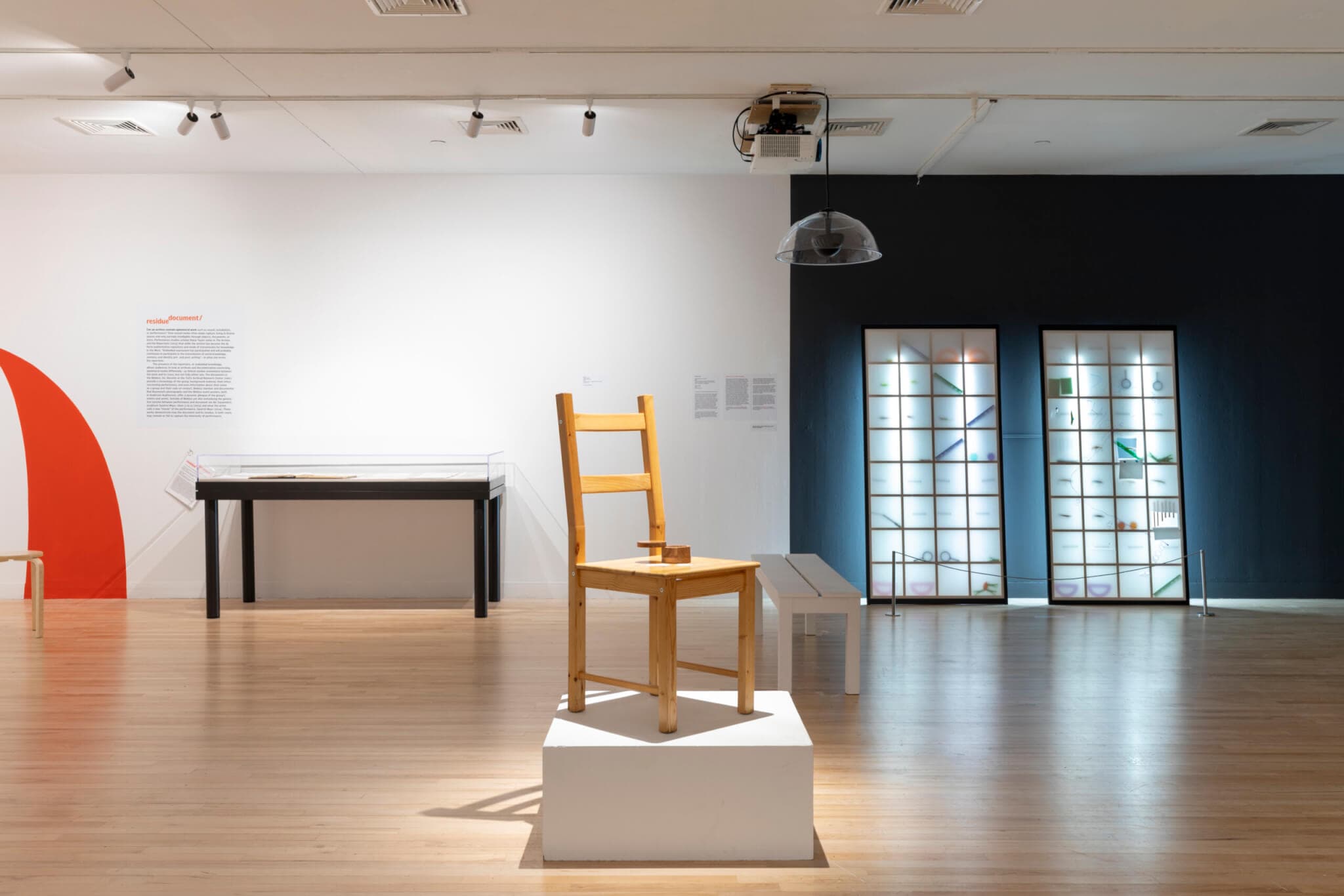 A wooden chair sets atop a pedestal.