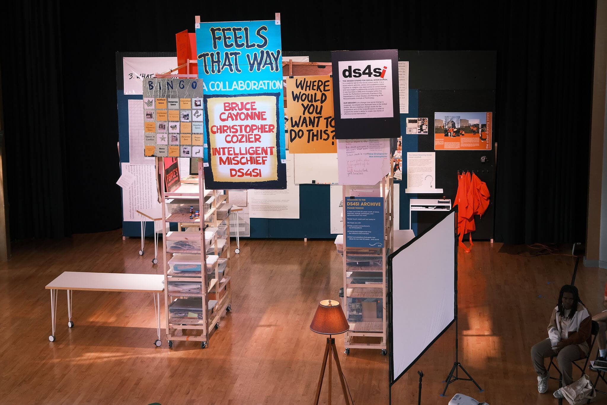 Posters and signs arranged on a stage.